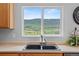 The kitchen sink has a window view of the grassy hills at 9721 Marmot Ridge Cir, Littleton, CO 80125
