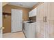 The laundry room features a full-sized washer and dryer, built-in storage, and ample space at 9721 Marmot Ridge Cir, Littleton, CO 80125