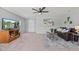 Bright and open living room with a ceiling fan, television, and comfortable seating at 9721 Marmot Ridge Cir, Littleton, CO 80125