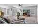 Bright and open living room with a ceiling fan, mountain views, and stylish furniture at 9721 Marmot Ridge Cir, Littleton, CO 80125