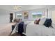 Sunlit bedroom features plush carpet, neutral walls, and bright window views at 9721 Marmot Ridge Cir, Littleton, CO 80125