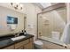 Updated bathroom with modern fixtures, shower-tub combo, and a vanity with countertop at 1901 S Union Pl, Lakewood, CO 80228