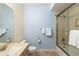 Guest bathroom includes vanity, toilet and shower with glass door at 1901 S Union Pl, Lakewood, CO 80228