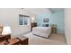 Basement bedroom with egress window and light-blue accent wall at 1901 S Union Pl, Lakewood, CO 80228