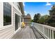 Large outdoor deck with wooden floor, white railing, and stylish chairs at 1901 S Union Pl, Lakewood, CO 80228