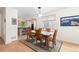 Dining room featuring hardwood floors and natural light open to a modern kitchen at 1901 S Union Pl, Lakewood, CO 80228