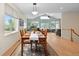 Bright dining room featuring vaulted ceiling, light hardwood floors, designer rug, and an open floor plan at 1901 S Union Pl, Lakewood, CO 80228