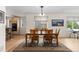 Well-lit dining room with hardwood floors, designer rug, natural light, and modern decor at 1901 S Union Pl, Lakewood, CO 80228