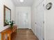 Inviting entryway featuring hardwood floors, white doors, and a decorative mirror at 1901 S Union Pl, Lakewood, CO 80228