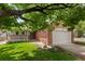 Beautiful home featuring a brick facade, well-maintained lawn, and an attached two-car garage at 1901 S Union Pl, Lakewood, CO 80228