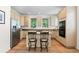 Well-lit kitchen featuring stainless steel appliances, granite countertops, and an island with seating at 1901 S Union Pl, Lakewood, CO 80228