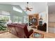 Spacious living room with vaulted ceiling, fireplace, hardwood floors, and large windows at 1901 S Union Pl, Lakewood, CO 80228