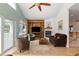 Cozy living room featuring a fireplace, built-in shelving, and a sliding door to outdoor area at 1901 S Union Pl, Lakewood, CO 80228