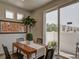 Cozy dining room with modern table and chairs, bright light, and sliding door to the outside at 13151 E 103Rd Pl, Commerce City, CO 80022