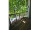 Charming wooden balcony with bright sunlight overlooking a refreshing pool and green trees at 2430 W 82Nd Pl # 2F, Westminster, CO 80031