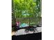 Charming balcony with floral decor overlooking a refreshing pool and green trees at 2430 W 82Nd Pl # 2F, Westminster, CO 80031