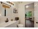 Bright bathroom featuring white vanity, updated fixture, and view into a sunroom at 2430 W 82Nd Pl # 2F, Westminster, CO 80031