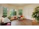 Bright bedroom featuring large windows with leafy tree views and plenty of natural light at 2430 W 82Nd Pl # 2F, Westminster, CO 80031
