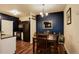 Stylish dining area with modern lighting and a dark accent wall at 2430 W 82Nd Pl # 2F, Westminster, CO 80031