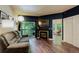 Comfortable living room with a fireplace, balcony access, and large windows for natural light at 2430 W 82Nd Pl # 2F, Westminster, CO 80031