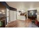Open-concept living room with hardwood floors, a cozy fireplace, and kitchen and dining room views at 2430 W 82Nd Pl # 2F, Westminster, CO 80031