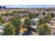 Aerial view of neighborhood with mature trees, community tennis courts and clubhouse at 2770 S Elmira St # 2, Denver, CO 80231