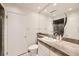 Bathroom featuring a vanity, round mirror, and walk-in shower at 2770 S Elmira St # 2, Denver, CO 80231