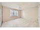 Bedroom with a large window, ceiling fan, and neutral carpeting at 2770 S Elmira St # 2, Denver, CO 80231