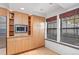 A view of the kitchen featuring a stainless microwave and natural wood cabinets at 2770 S Elmira St # 2, Denver, CO 80231