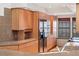 A view of the kitchen featuring stainless appliances, granite counters, and natural wood cabinets at 2770 S Elmira St # 2, Denver, CO 80231