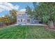 Spacious backyard with a well-maintained lawn, a patio, and mature trees at 5109 S Malta Way, Centennial, CO 80015
