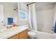 Bright full bathroom with a shower-tub combo and window at 5109 S Malta Way, Centennial, CO 80015