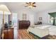 Spacious bedroom featuring hardwood floors, ceiling fan, and a large closet at 5109 S Malta Way, Centennial, CO 80015