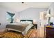 Comfortable bedroom featuring wood floors, a queen size bed, and natural light at 5109 S Malta Way, Centennial, CO 80015