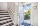 Inviting entryway features a staircase and an open door with natural light at 5109 S Malta Way, Centennial, CO 80015