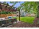 Landscaped backyard featuring outdoor seating, a pergola, a fire pit, a grill and a lush green lawn at 3881 Zenobia St, Denver, CO 80212