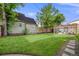 Beautiful backyard featuring a lush lawn, mature trees, patio area, and pergola, perfect for outdoor entertaining at 3881 Zenobia St, Denver, CO 80212