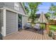 Back deck featuring a door to the house, outdoor seating, and a view of the landscaped yard at 3881 Zenobia St, Denver, CO 80212
