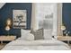 Stylish bedroom featuring decoratively adorned nightstands, luxury bedding, hardwood floors and a window with natural light at 3881 Zenobia St, Denver, CO 80212