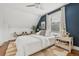 Bright bedroom featuring a ceiling fan, natural light, an accent wall, and hardwood floors with decorative rug at 3881 Zenobia St, Denver, CO 80212