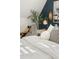 Well-lit bedroom featuring decorative plants, and an accent wall with gold gilded mirror, and a window with natural light at 3881 Zenobia St, Denver, CO 80212