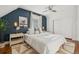 Stylish bedroom featuring decoratively adorned nightstands, luxury bedding, hardwood floors and a closet at 3881 Zenobia St, Denver, CO 80212