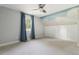 Bright bedroom featuring a ceiling fan, light gray walls, cloud mural, and a window with blue curtains at 3881 Zenobia St, Denver, CO 80212