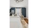 Bright bedroom featuring a ceiling fan, natural light, an accent wall, and hardwood floors with decorative rug at 3881 Zenobia St, Denver, CO 80212