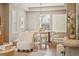 Bright dining room with modern light fixture, light walls, wood floors and unique wall art at 3881 Zenobia St, Denver, CO 80212