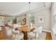 Open floor plan with dining area featuring wooden table and modern decor, with living room in background at 3881 Zenobia St, Denver, CO 80212