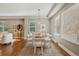 Inviting dining area with light walls, wood floors, and a modern wooden table set for six at 3881 Zenobia St, Denver, CO 80212