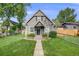 Charming gray home with a well-manicured lawn and lovely landscaping on a sunny day at 3881 Zenobia St, Denver, CO 80212