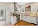 Well-lit kitchen with stainless steel appliances, mosaic backsplash, granite countertops, and wood floors at 3881 Zenobia St, Denver, CO 80212