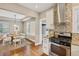 View of the dining room from the kitchen, highlighting the open floor plan and wood floors at 3881 Zenobia St, Denver, CO 80212